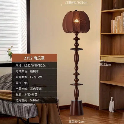 A tall dark walnut finished decorbites chinese tassels floor lamp with a pumpkin shaped woven fabric shade and ornate wooden stem