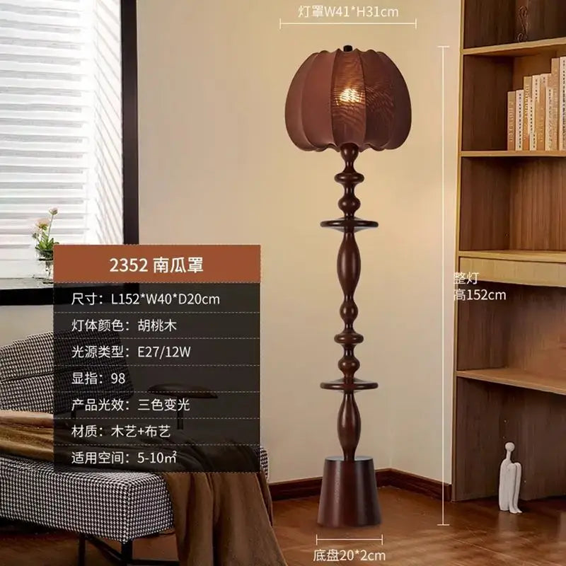 A tall dark walnut finished decorbites chinese tassels floor lamp with a pumpkin shaped woven fabric shade and ornate wooden stem