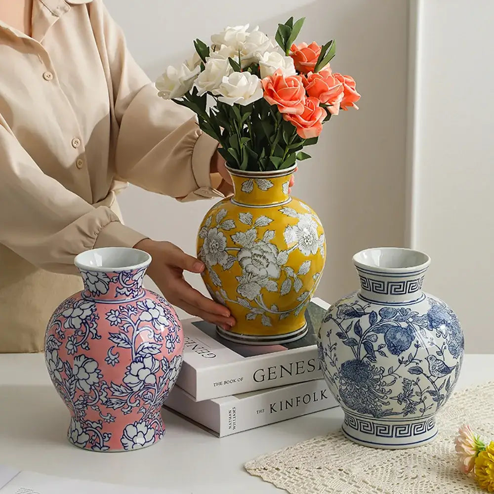 Yellow ceramic vase with white floral patterns and decorative neck featuring traditional blue white porcelain design