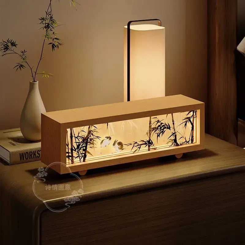 A rectangular wooden decorbites chinese wind lamp night light with black bamboo and bird silhouettes and warm glow