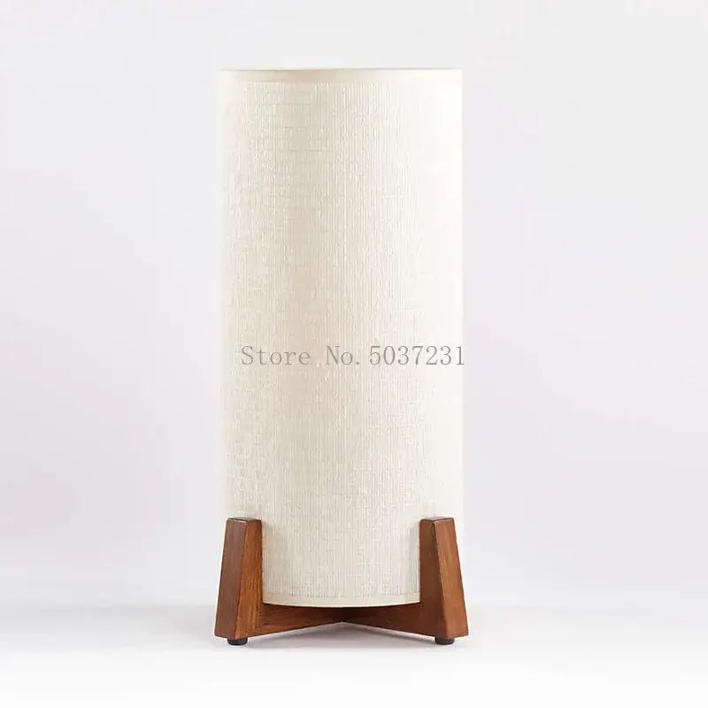 Cream-colored cylindrical lampshade with textured fabric on minimalist zen wooden floor lamp for living room or bedroom