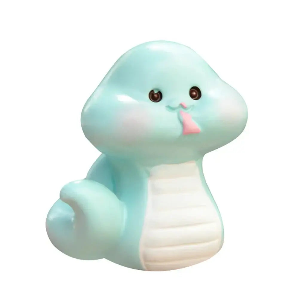 A pastel blue squishy snake figurine with white belly and pink tongue from decorbites amethyst tree figurines for home decor