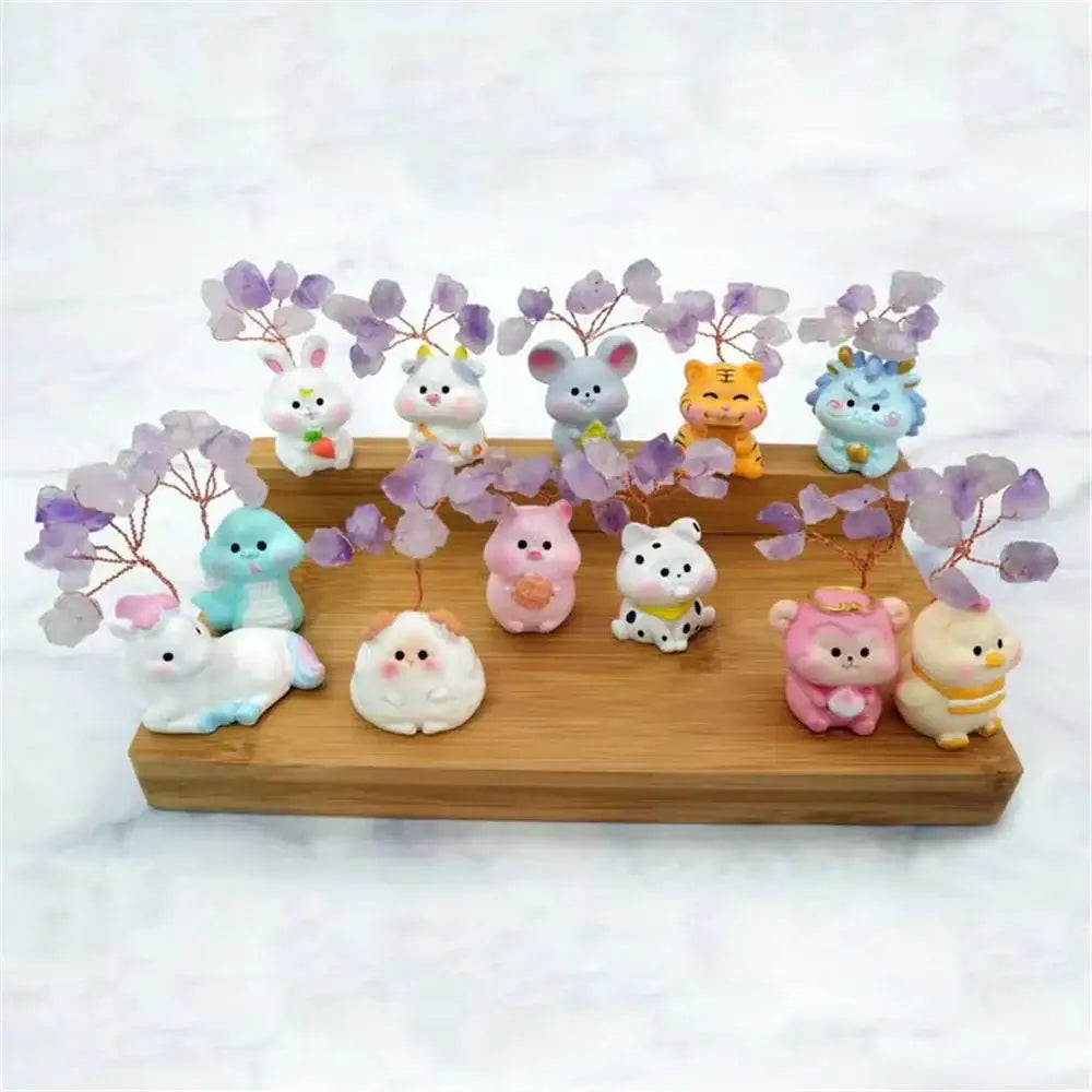 A collection of colorful cute animal figurines with purple amethyst tree branches on a wooden tray for home decor