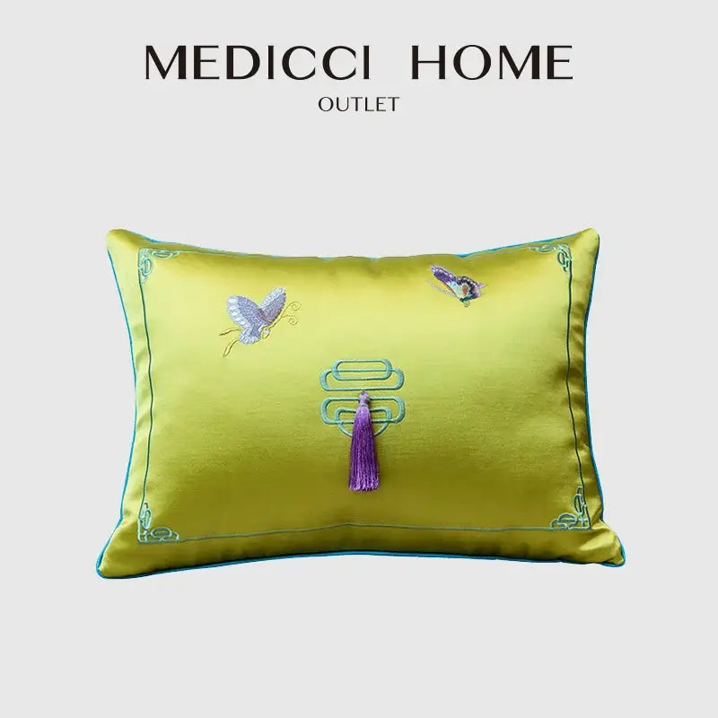 A vibrant yellow satin cushion cover with chinoiserie butterfly embroidered design and purple tassel by decorbites