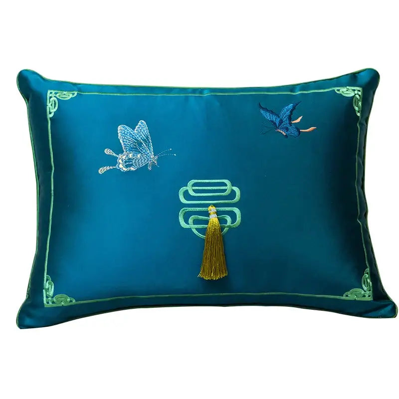 Deep teal silk cushion cover with intricate green chinoiserie butterfly embroidered design and golden tassel by decorbites