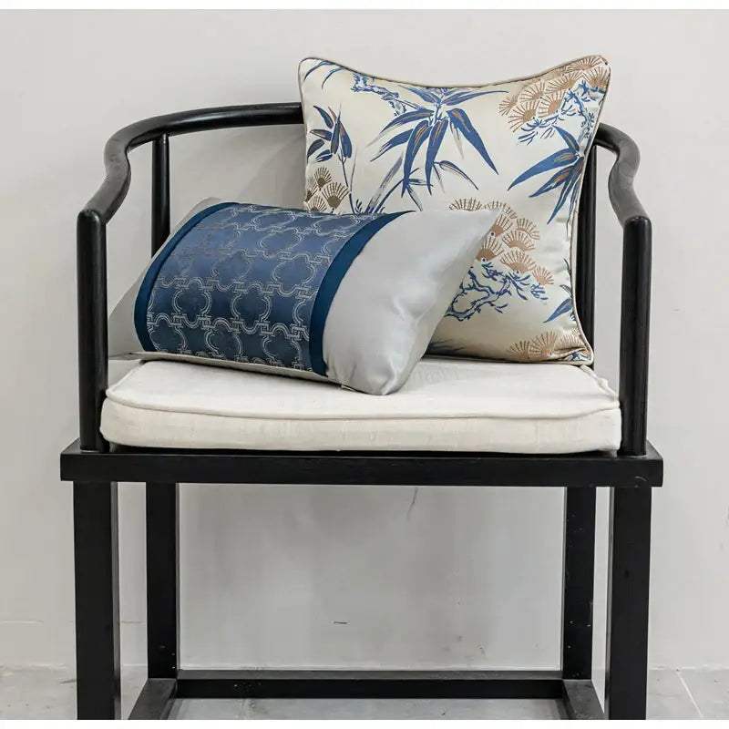 Blue and silver decorbites chinoiserie decor throw pillow cover with intricate geometric pattern on black chair