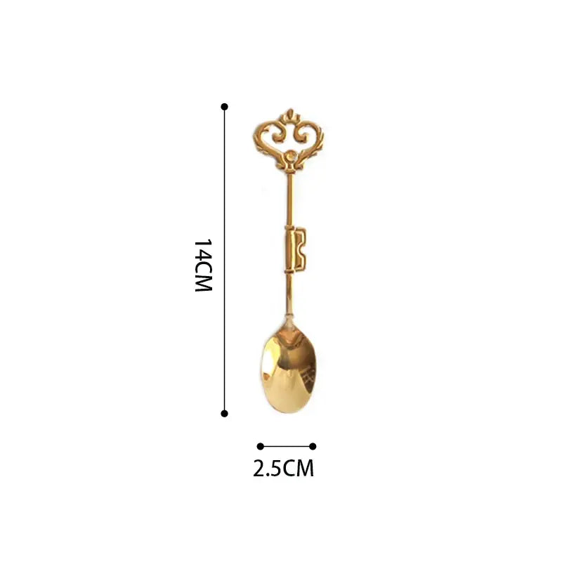 A golden key-shaped spoon with an ornate vintage handle and polished metal finish for decorbites chinoiserie floral birds dinner
