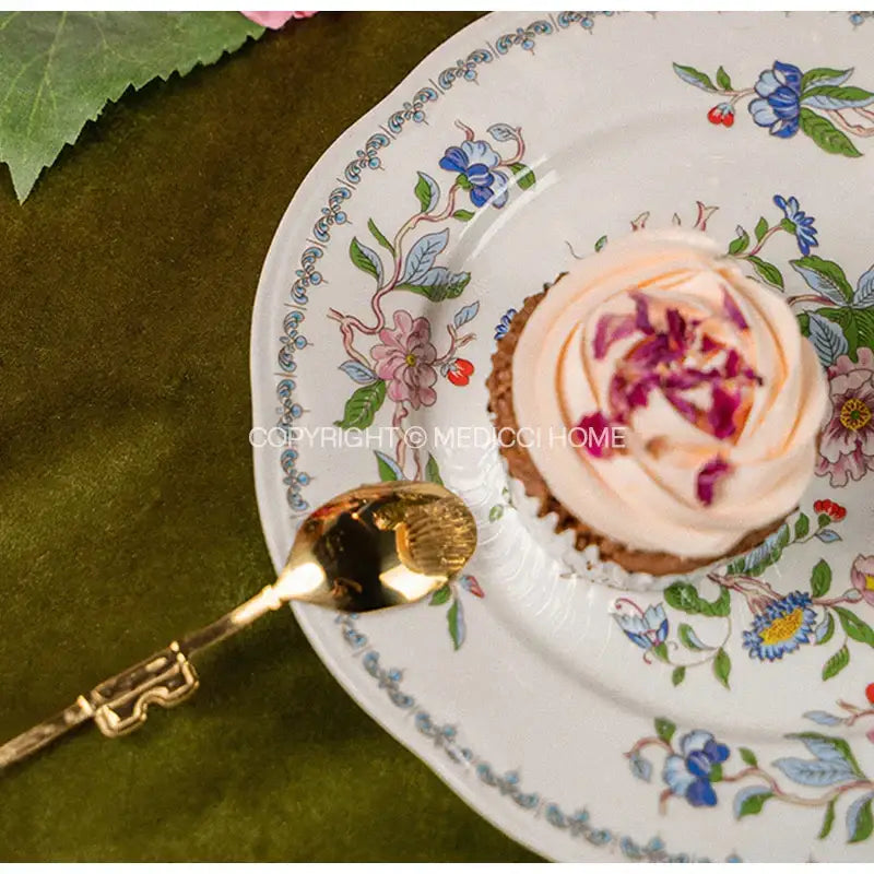 A delicate white porcelain decorbites chinoiserie floral birds dinner plate with intricate blue pink and green patterns