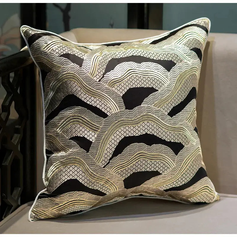 Square cushion cover with intricate black and gold chinoiserie golden embroidered wave pattern and white border by decorbites
