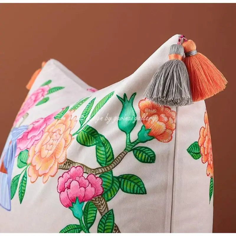 A cream-colored canvas decorbites chinoiserie monkey umbrella pillowcase with vibrant floral embroidery and tassel accents