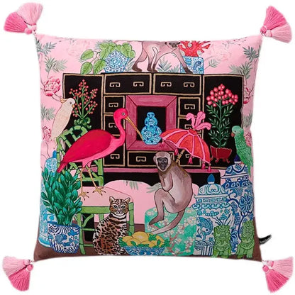 Pink cushion with decorbites chinoiserie monkey umbrella peonies design featuring animals and pink tassels at corners