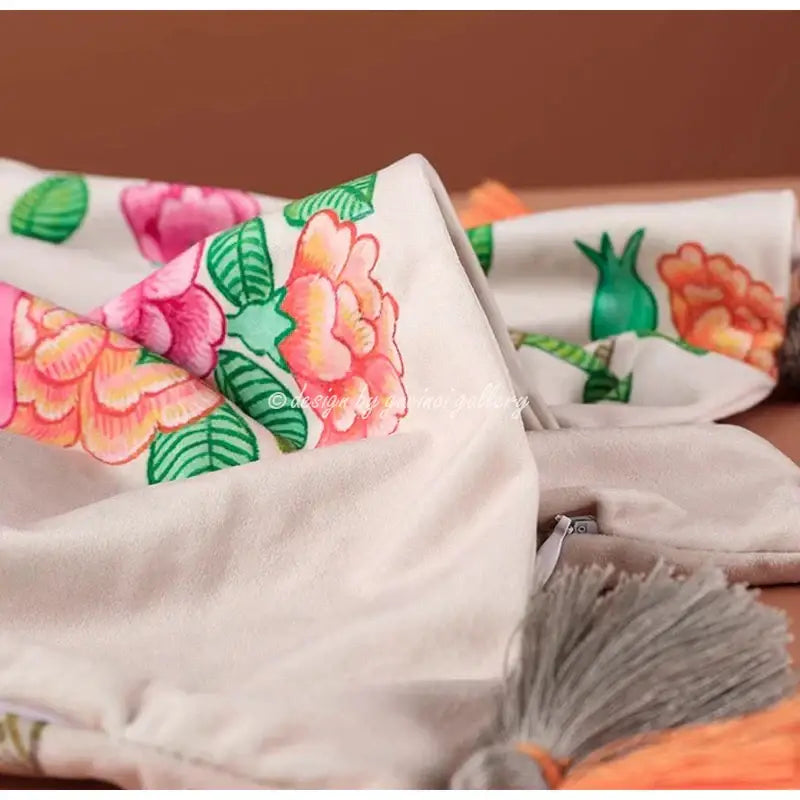 A soft off-white decorbites chinoiserie monkey umbrella throw blanket with vibrant pink and orange monkey umbrella peonies