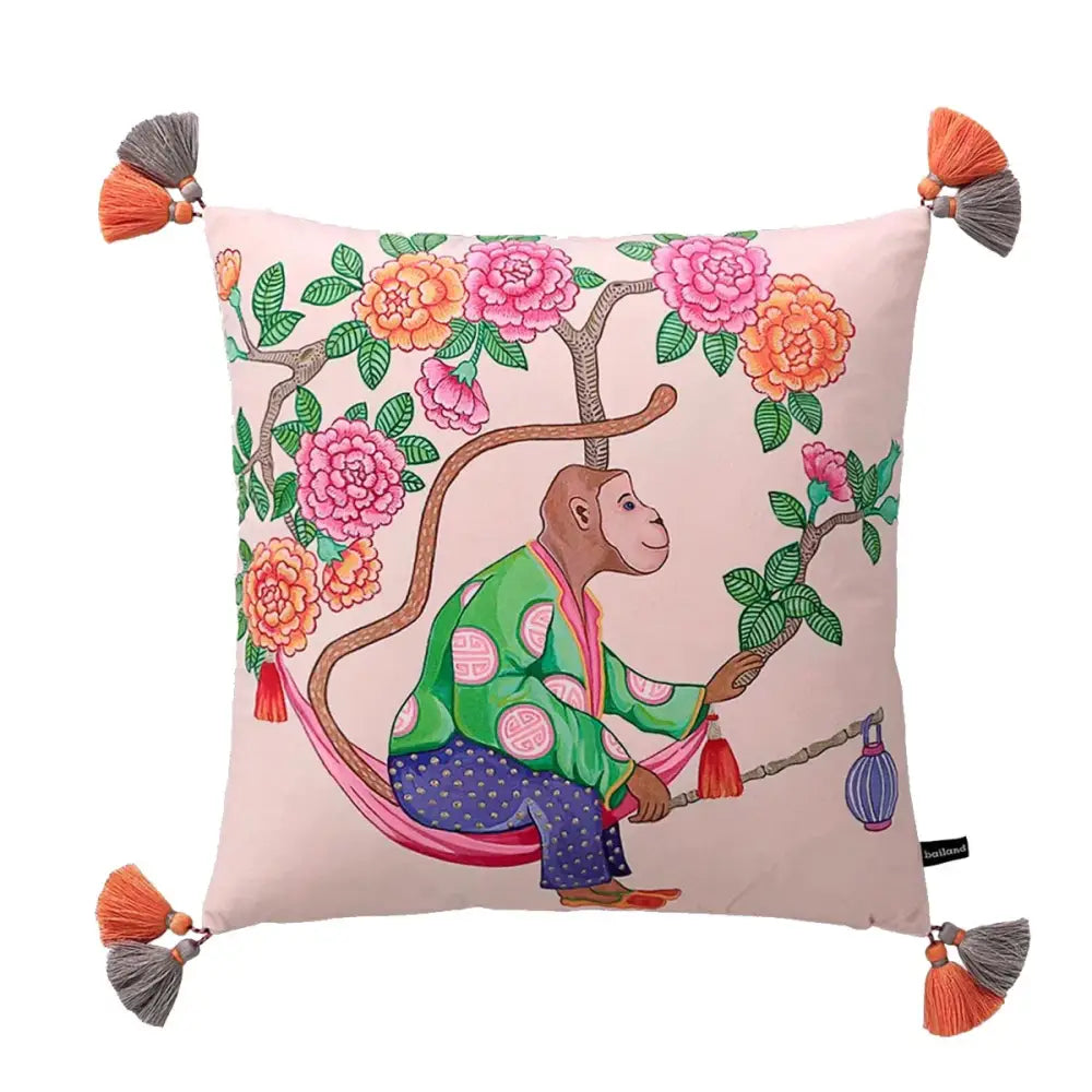 Pink cushion featuring decorbites chinoiserie monkey umbrella design with peonies and orange gray tassels at corners