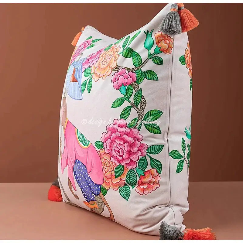 A vibrant off-white decorbites chinoiserie monkey umbrella pillowcase with embroidered pink and orange peonies and colorful tassels