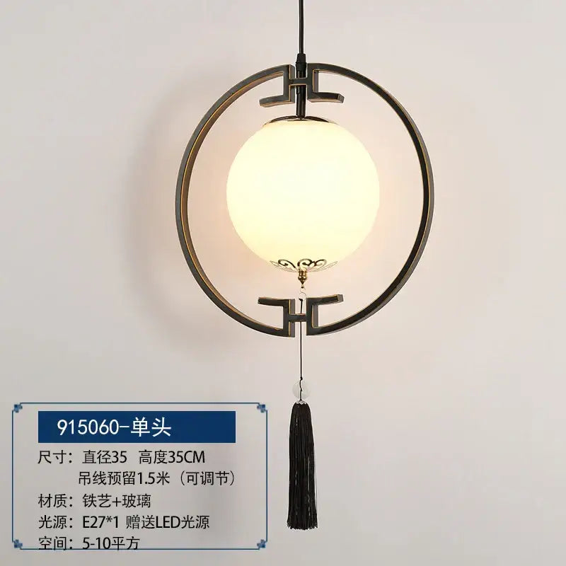 Black circular pendant light with frosted glass globe and ornate tassel in decorbites chinoiserie retro chandelier