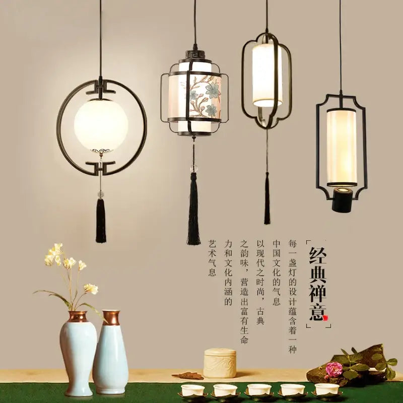 Four elegant black metal framed hanging lanterns with warm glass shades in decorbites chinoiserie retro chandelier