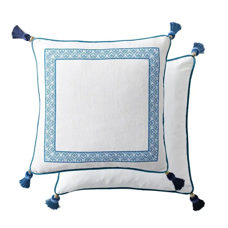 White lumbar pillow case with blue embroidered border and tassels from decorbites chinoiserie collection