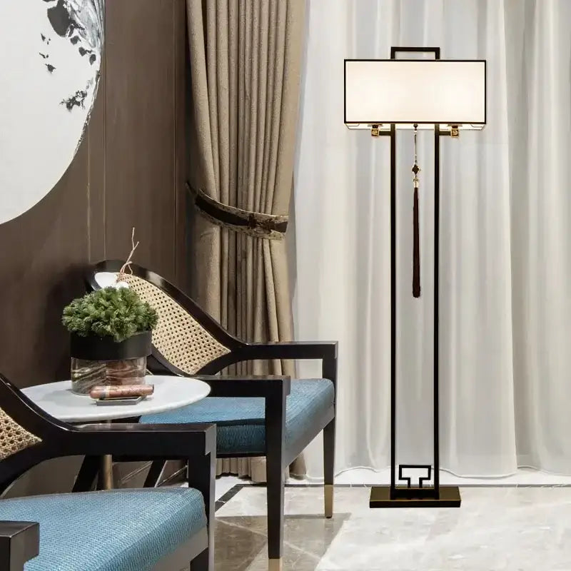Modern black metal floor lamp with a rectangular white shade and tassel in decorbites chinoiserie style floor design