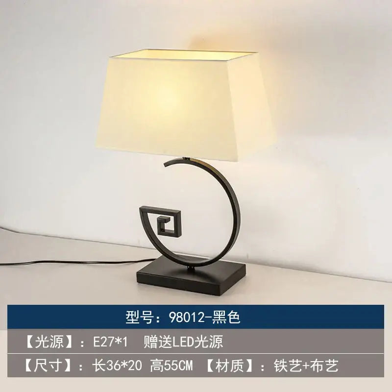 Black metal floor lamp with cream fabric shade and curved base in decorbites chinoiserie table floor lamp design