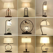 A collection of nine decorbites chinoiserie table floor lamps with black metal frames and cream fabric shades for elegant lighting