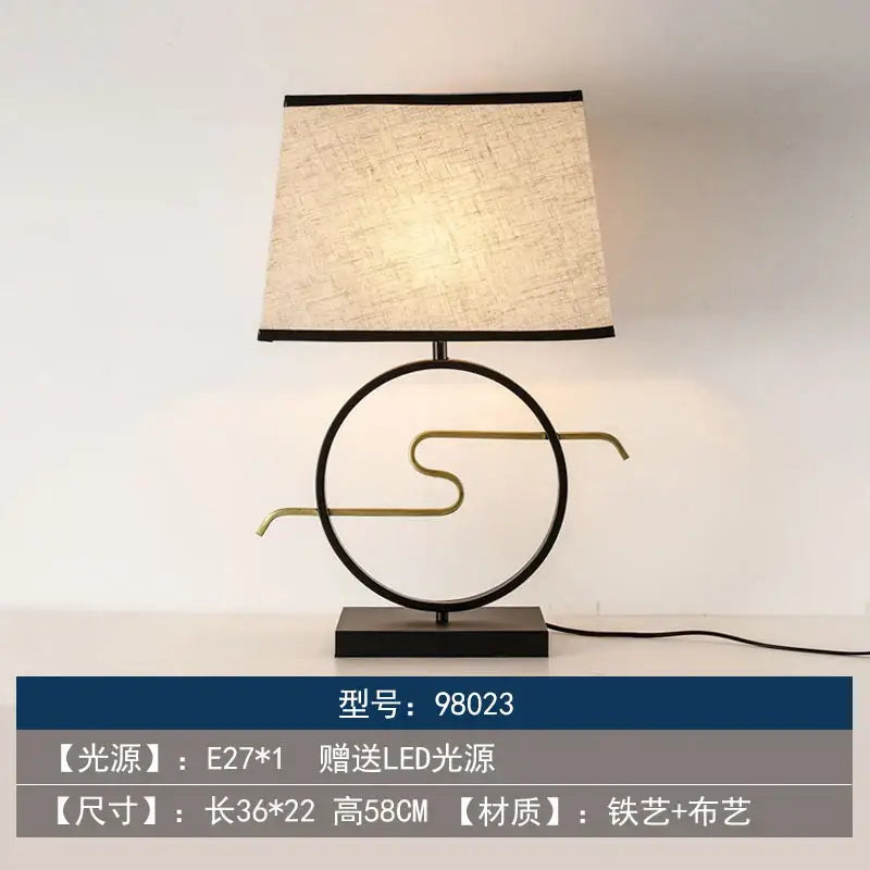 Modern floor lamp with black metal abstract circular base and beige fabric shade from decorbites chinoiserie table floor collection