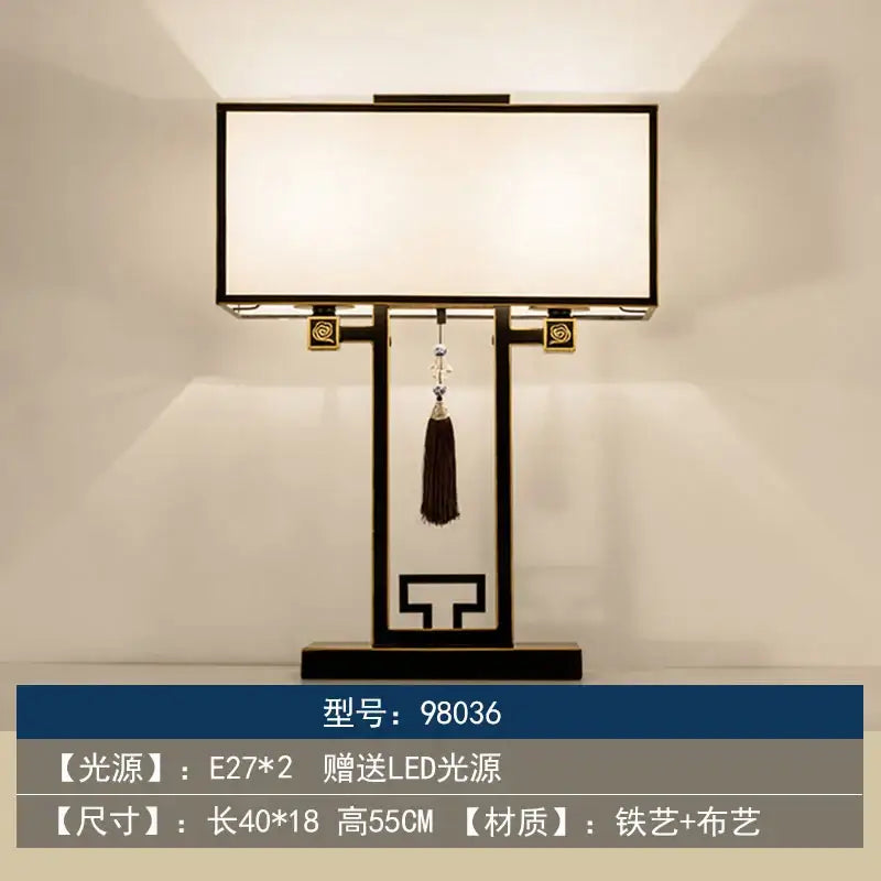Black metal decorbites chinoiserie table floor lamp with white fabric shade gold accents and hanging dark tassel