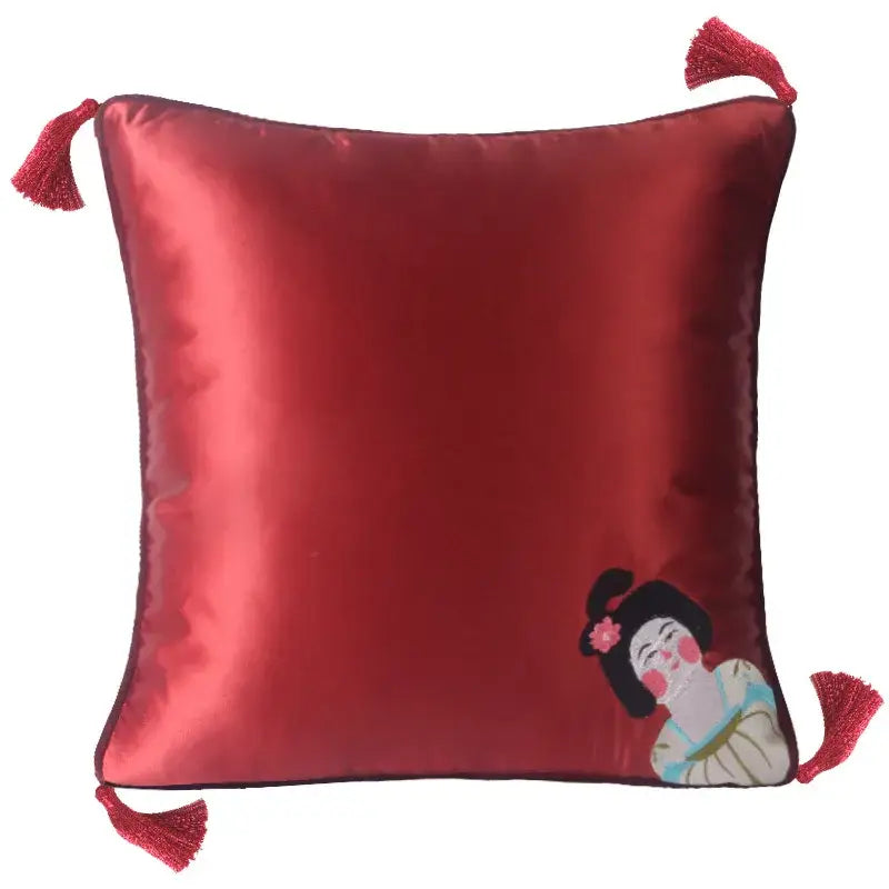 A rich red satin decorbites chinoiserie tang dynasty cushion cover with embroidered geisha design and tassels