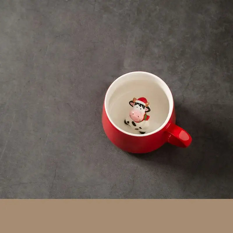 Red porcelain christmas animals ceramic tea cup featuring a red mug with a cow figurine wearing a santa hat inside