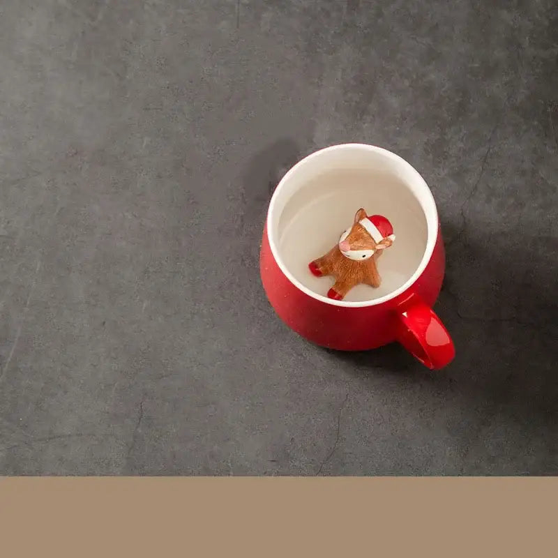 Red porcelain christmas animals ceramic tea cup with a small brown deer figurine wearing a santa hat