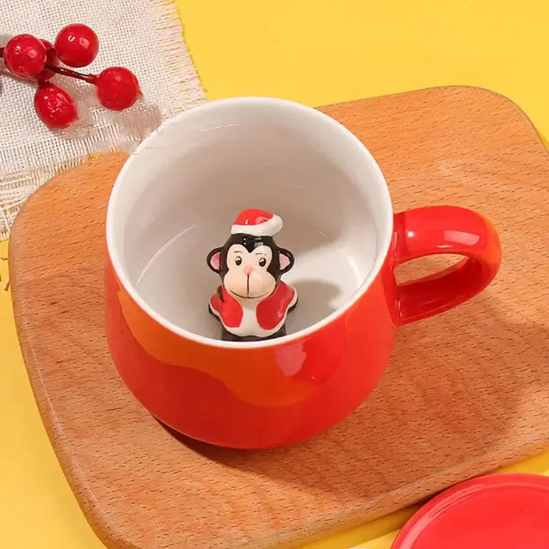 Red ceramic mug with a black and white monkey figurine wearing a santa hat from decorbites christmas animals ceramic set