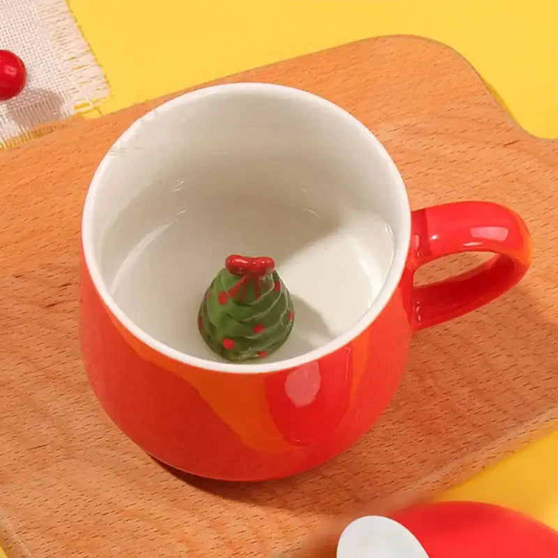 Vibrant red porcelain christmas animals ceramic mug with a glossy finish and a miniature green christmas tree figurine inside