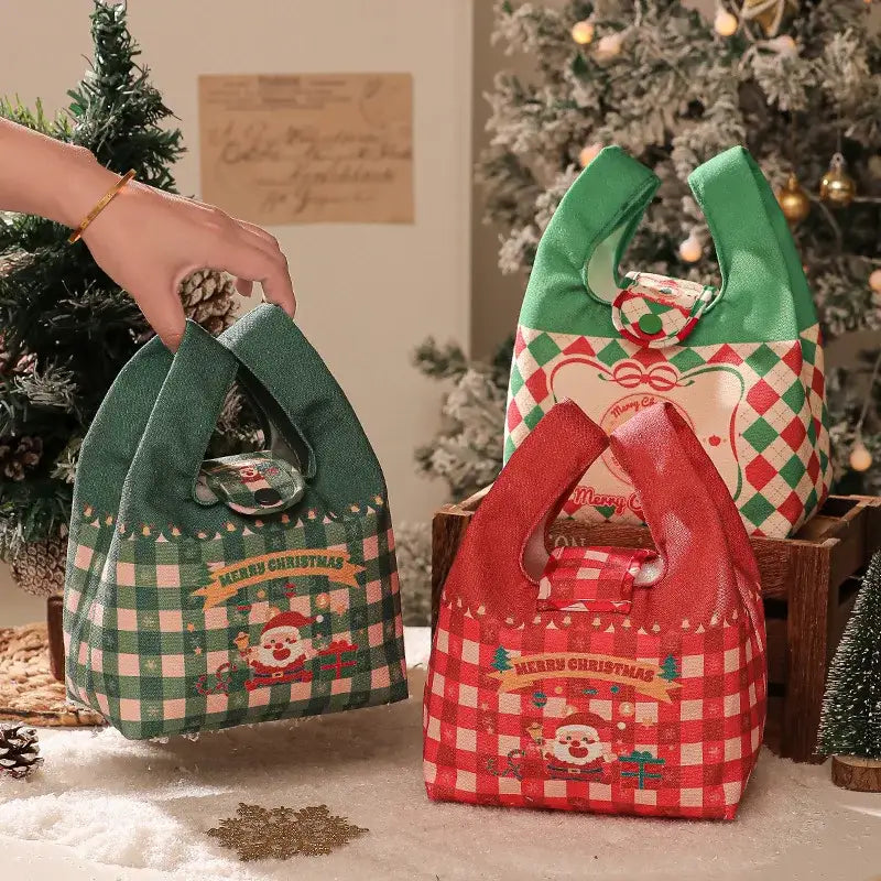Green and red checkered christmas apple handheld plush gift bag with santa illustration by decorbites christmas apple
