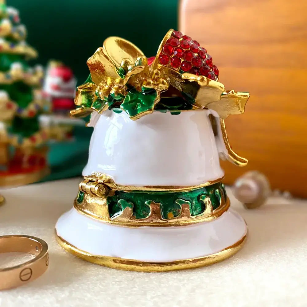 DecorBites™ white enamel bell trinket box with gold trim, green holly, red rhinestone bow, and jewelry storage clasp
