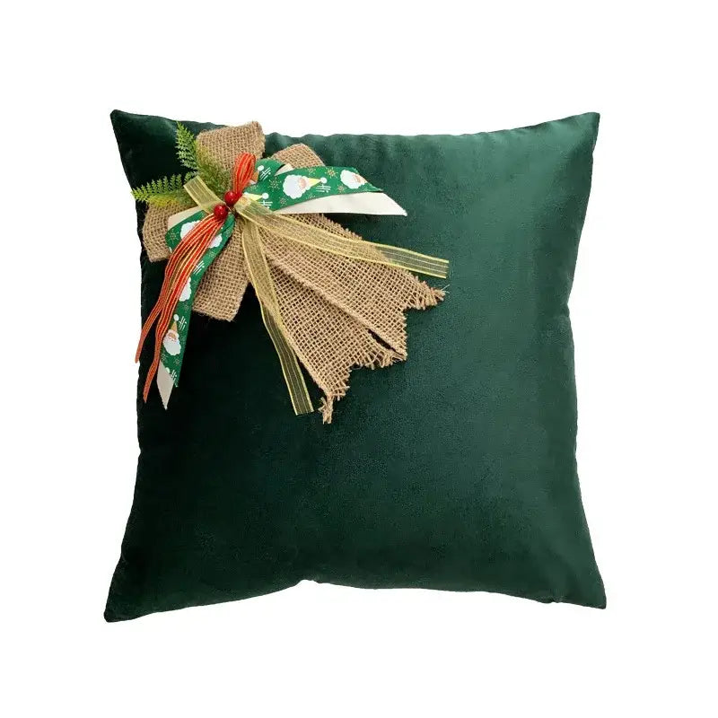 Deep green velvet throw pillow with decorbites christmas bow patchwork ribbon and faux evergreen accents