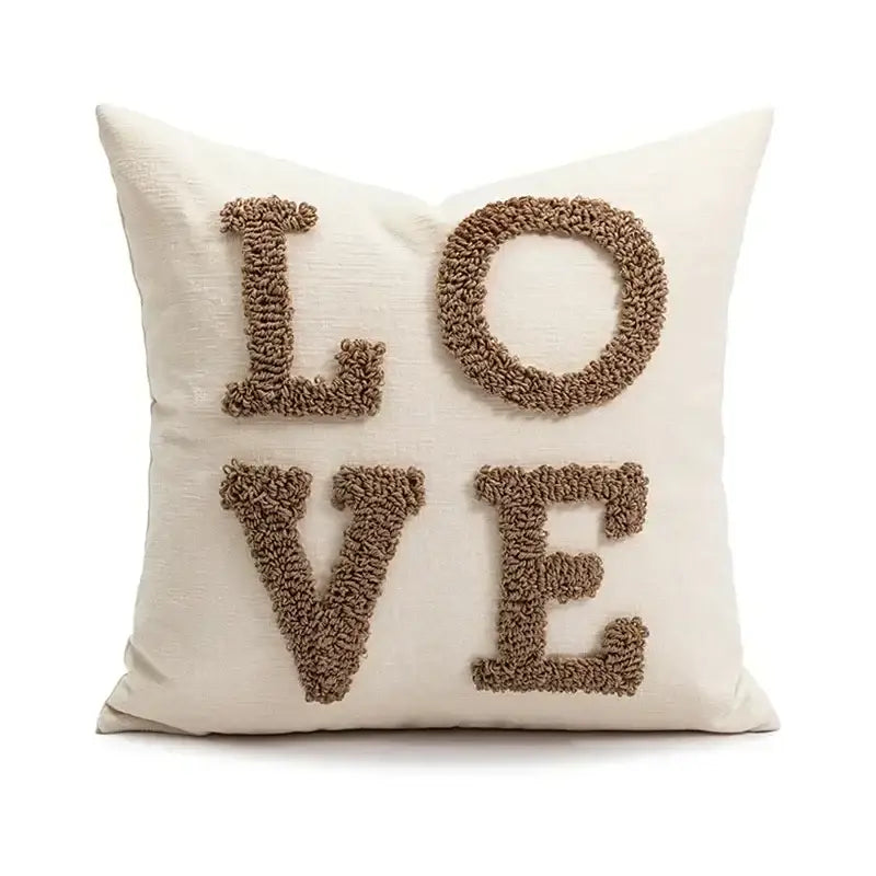 Cream-colored decorbites christmas candy cushion with textured brown yarn letters spelling love for festive sofa decor
