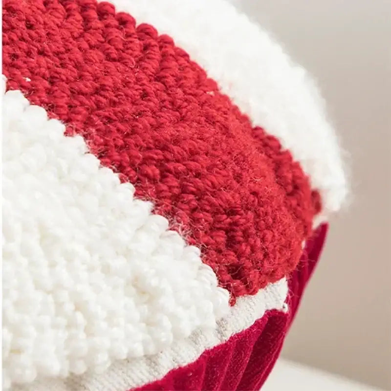 Red and white knitted plush hat with chunky texture featured in decorbites christmas candy cushions collection