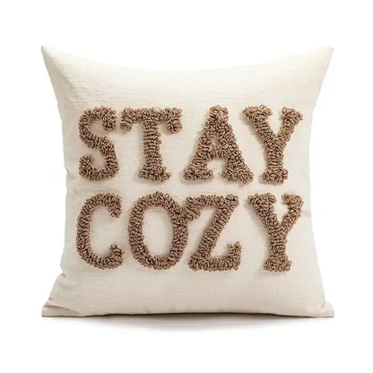 Cream-colored decorbites christmas candy cushion with stay cozy embroidered in textured beige yarn for festive sofa decor