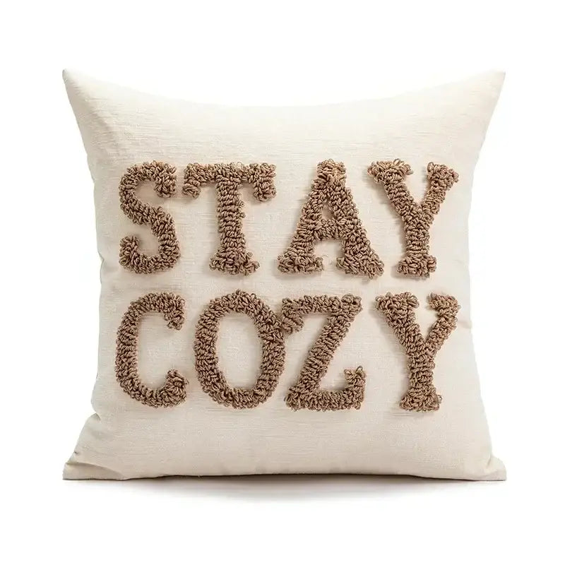 Cream-colored decorbites christmas candy cushion with stay cozy embroidered in textured beige yarn for festive sofa decor