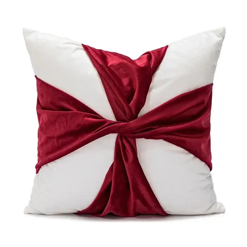 White cushion with a rich burgundy velvet ribbon tied in an elegant crossbow knot from decorbites christmas candy cushions