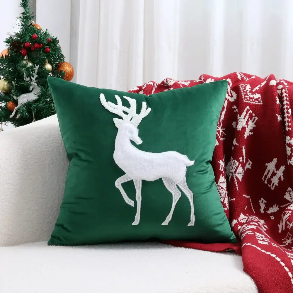 Deep green velvet pillow cover with white embroidered reindeer design from decorbites christmas cartoon set
