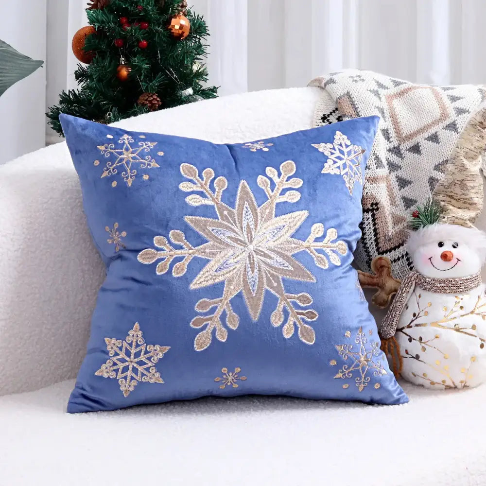 Blue velvet pillow cover with intricate gold and silver embroidered snowflakes from decorbites christmas cartoon set