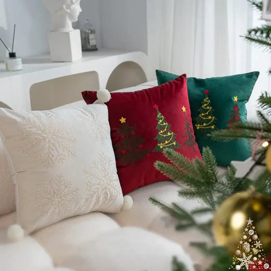 Red velvet pillow cover with green embroidered trees gold stars and white pom-pom from decorbites christmas cartoon set