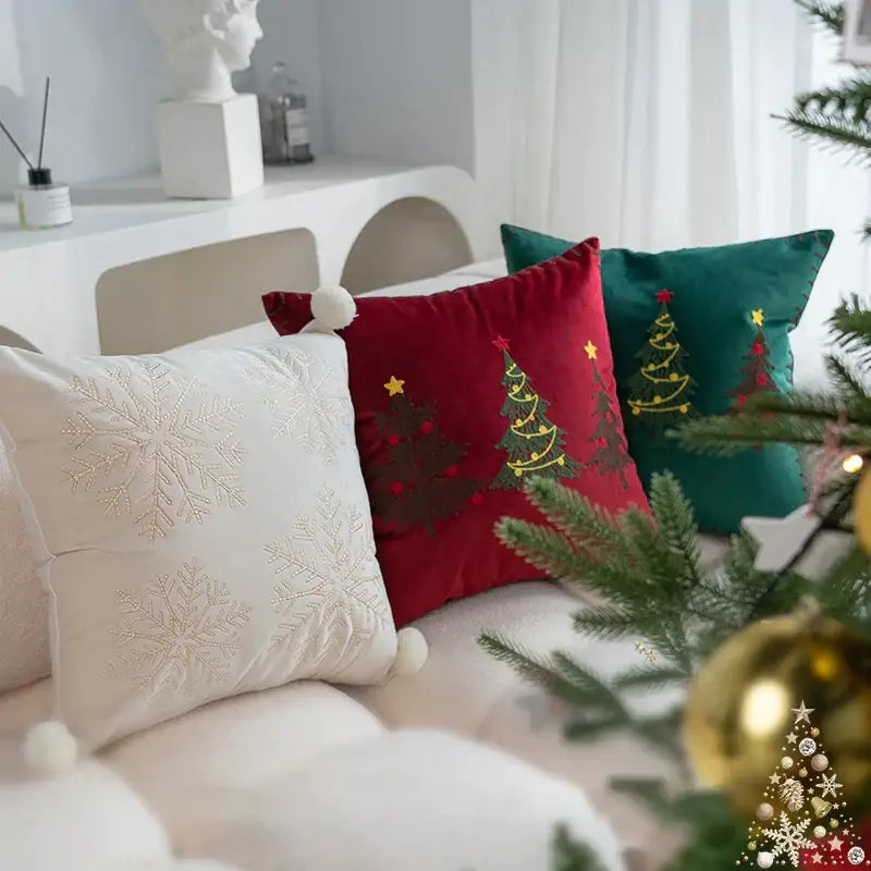 Red velvet pillow cover with green embroidered trees gold stars and white pom-pom from decorbites christmas cartoon set
