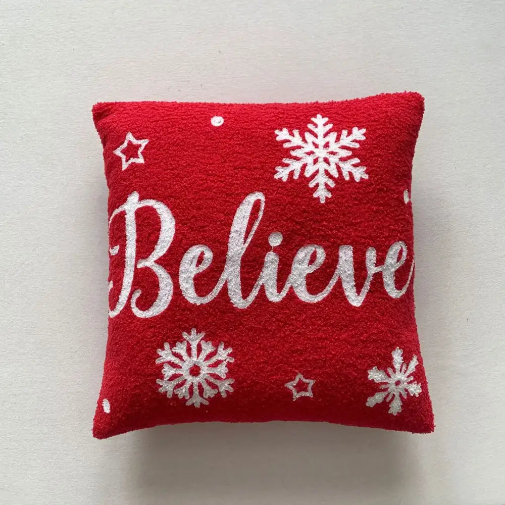 Red textured embroidered pillow with white snowflakes stars and silver glitter believe script decorbites christmas cartoon