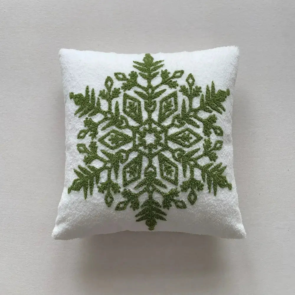 White cushion with intricate olive green embroidered snowflake in decorbites christmas cartoon embroidered pillow set