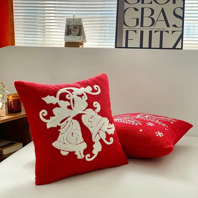 Red throw pillow cover with white embroidered bells and swirling patterns from decorbites christmas cartoon collection