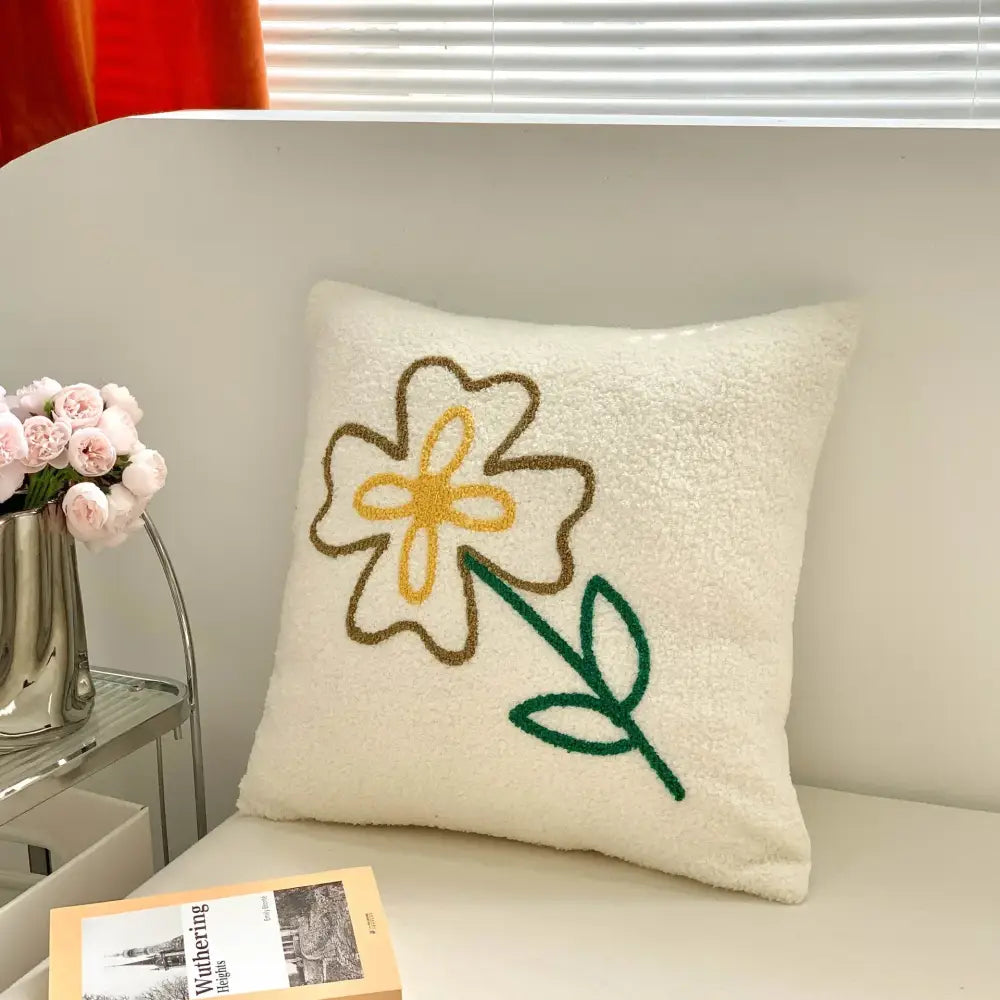 Cream-colored fluffy pillow cover with embroidered yellow flower and green stem decorbites christmas cartoon festive design