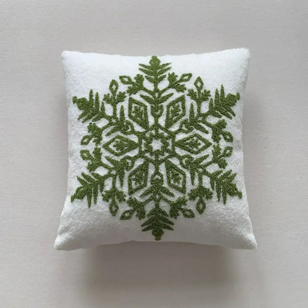 White plush pillow cover with intricate olive green embroidered snowflake design from decorbites christmas cartoon collection