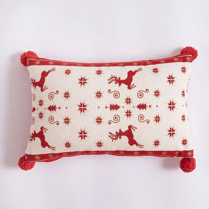 Cream-colored rectangular pillow with red embroidered reindeer and tassels complements dining room table runner decor