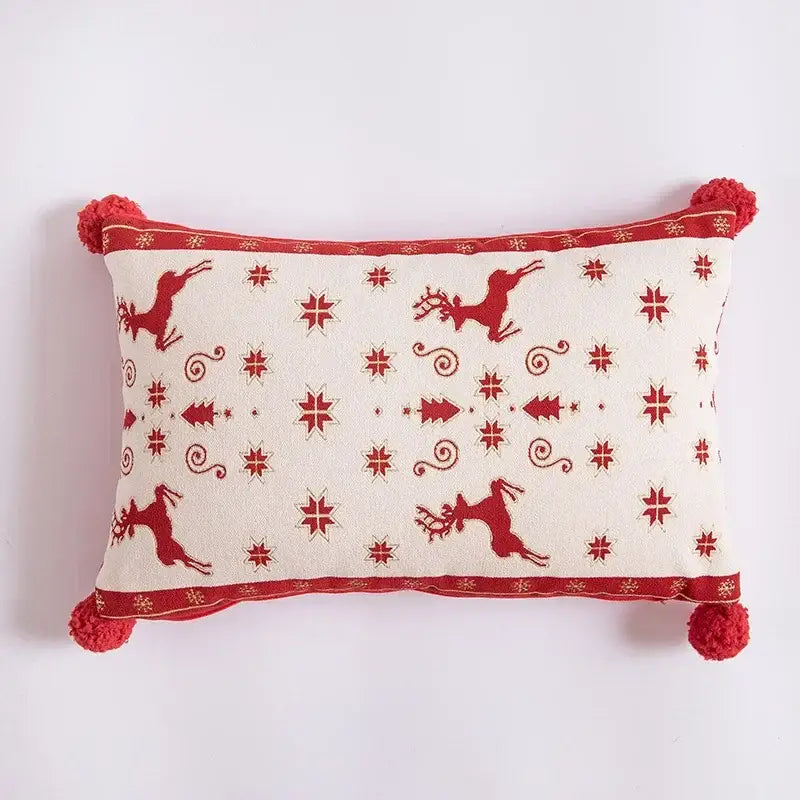 Cream-colored rectangular pillow with red embroidered reindeer and tassels complements dining room table runner decor